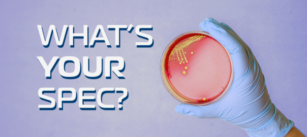 "What's Your Spec" article highlight. Glove holding petri dish with bacteria.